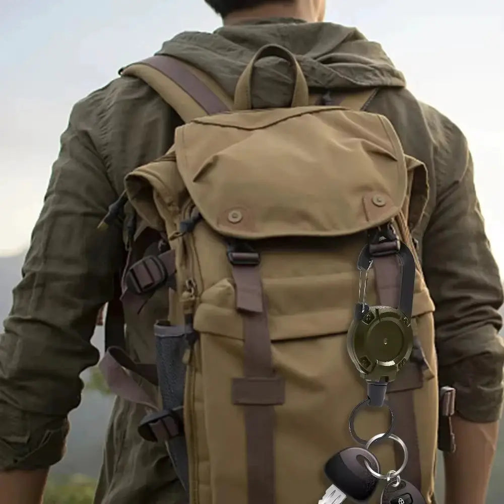 Retractable heavy-duty pull reel carabiner keychain attached to olive-green backpack strap