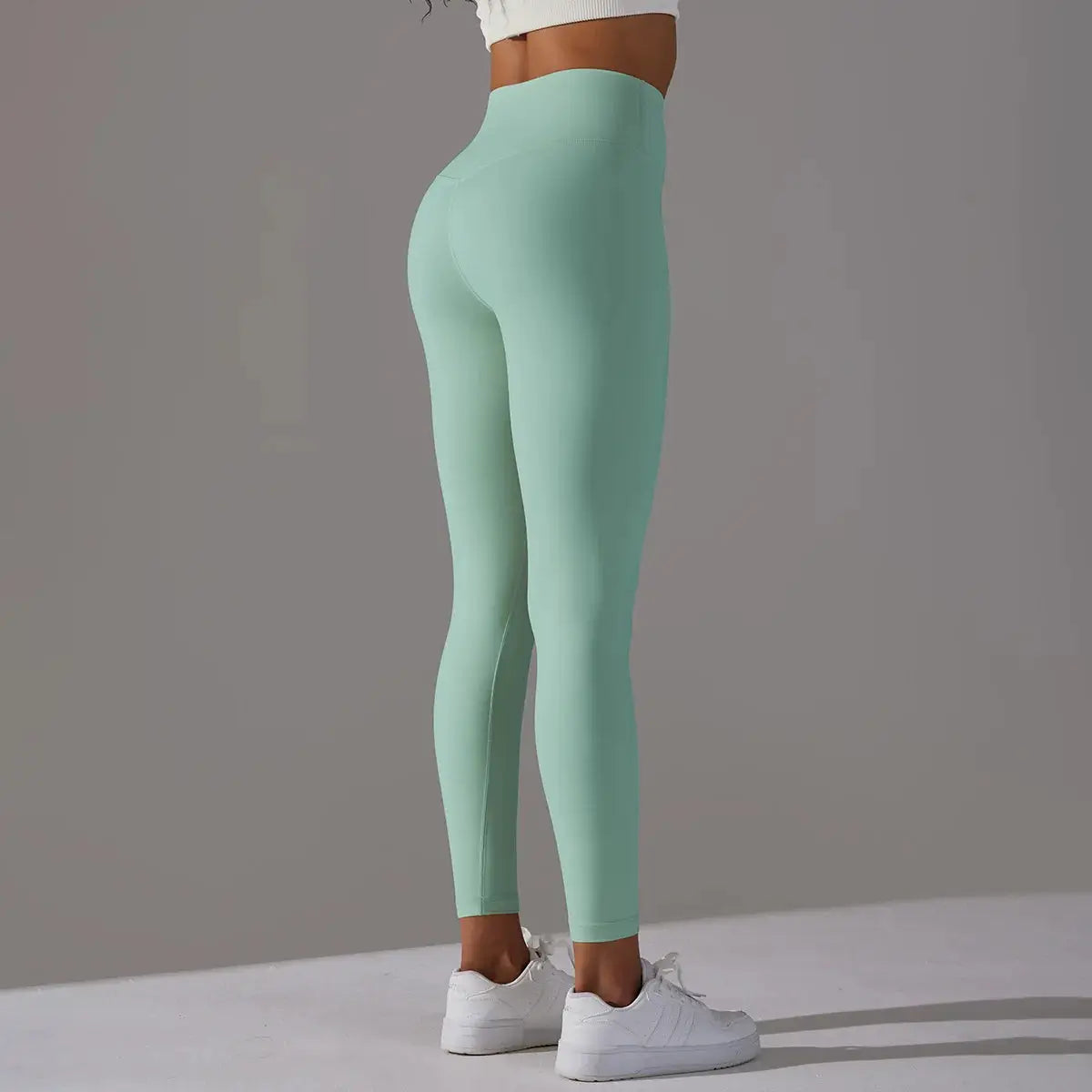 Women's high-waist naked-feeling leggings in mint green for yoga and gym workouts