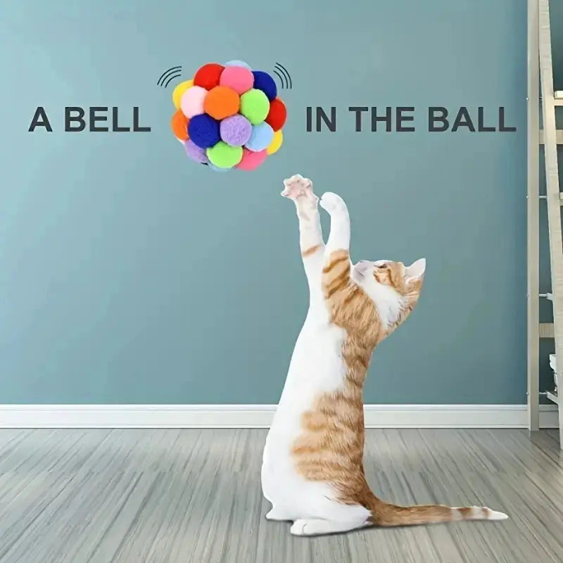 Cat plush ball toy with colorful woolen pom-poms for interactive play.