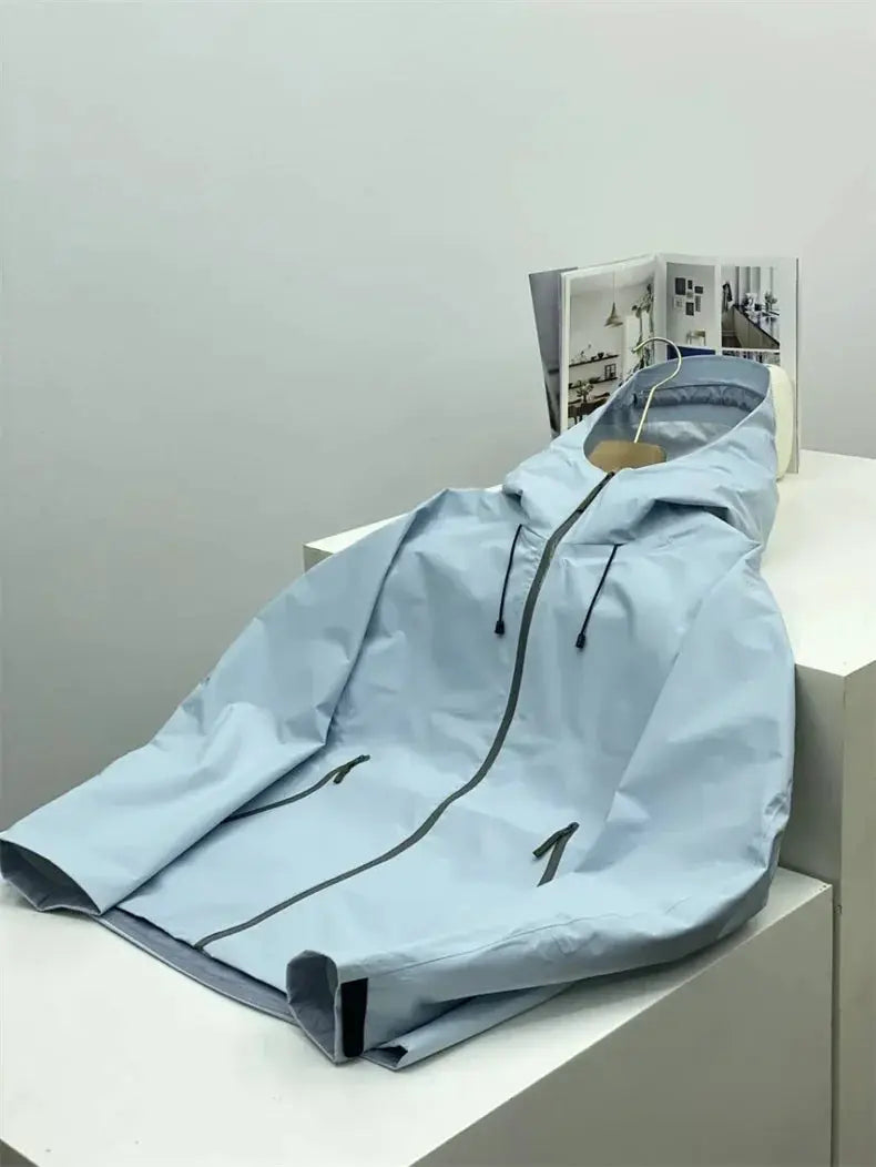 Soft-shell jacket, light blue, hooded windproof with front zip and zip pockets