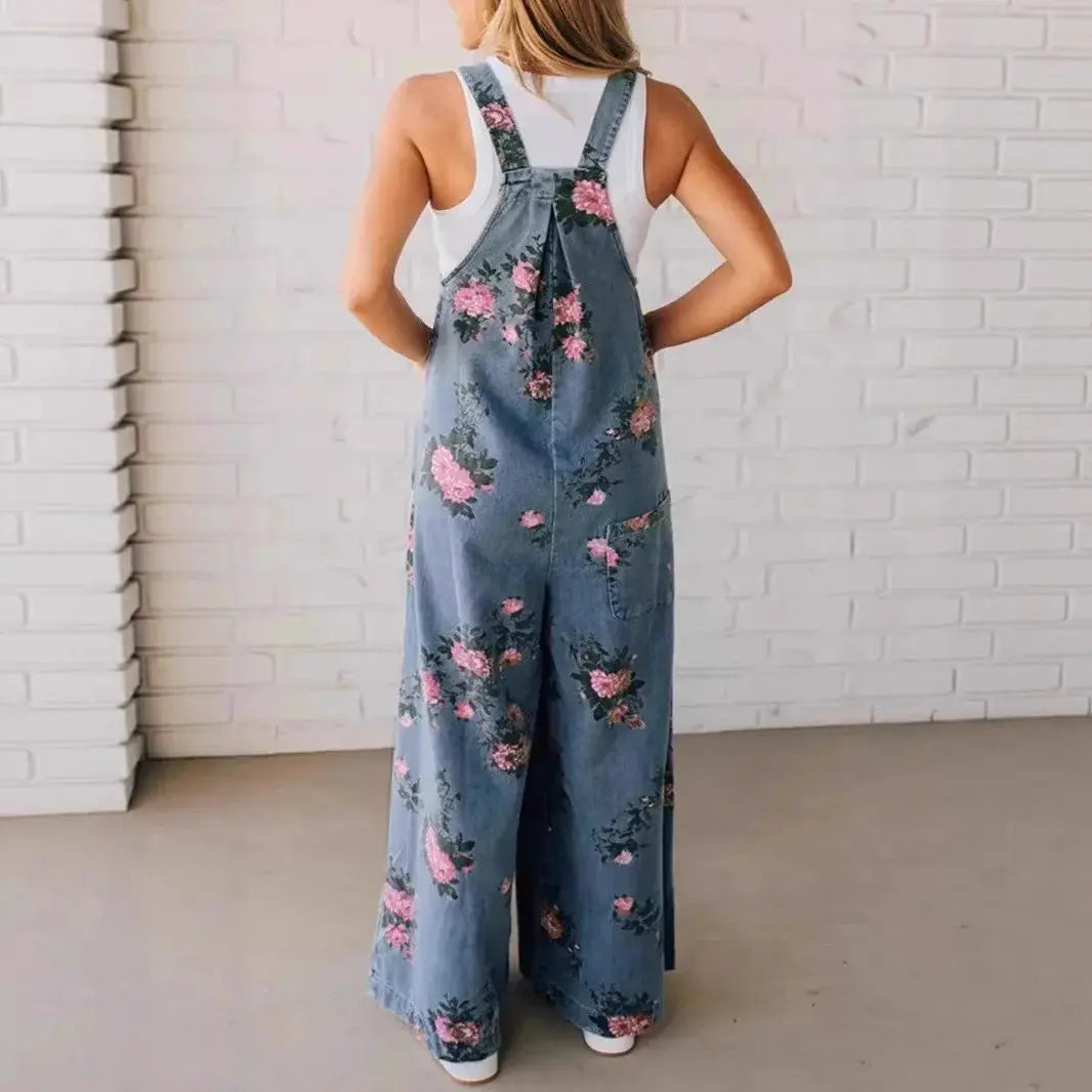 Denim floral print sleeveless jumpsuit for women, blue denim with pink flowers, loose wide-leg overalls with pockets.