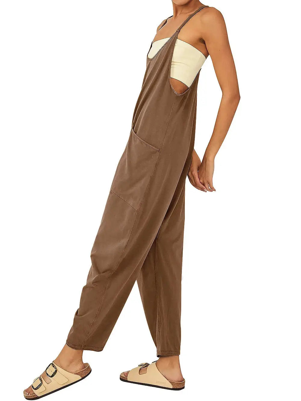 Women's brown suspender jumpsuit with patch pockets, loose fit, paired with beige sandals