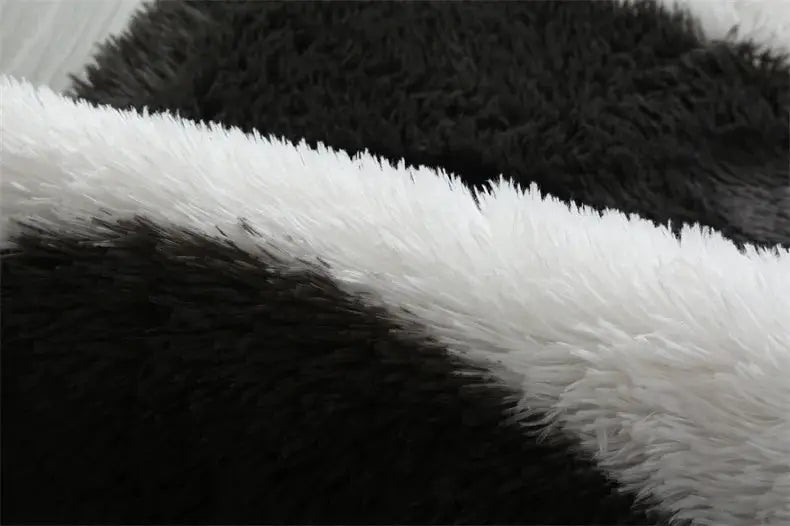 Fluffy area rug black and white shag with ultra-soft plush fibers.