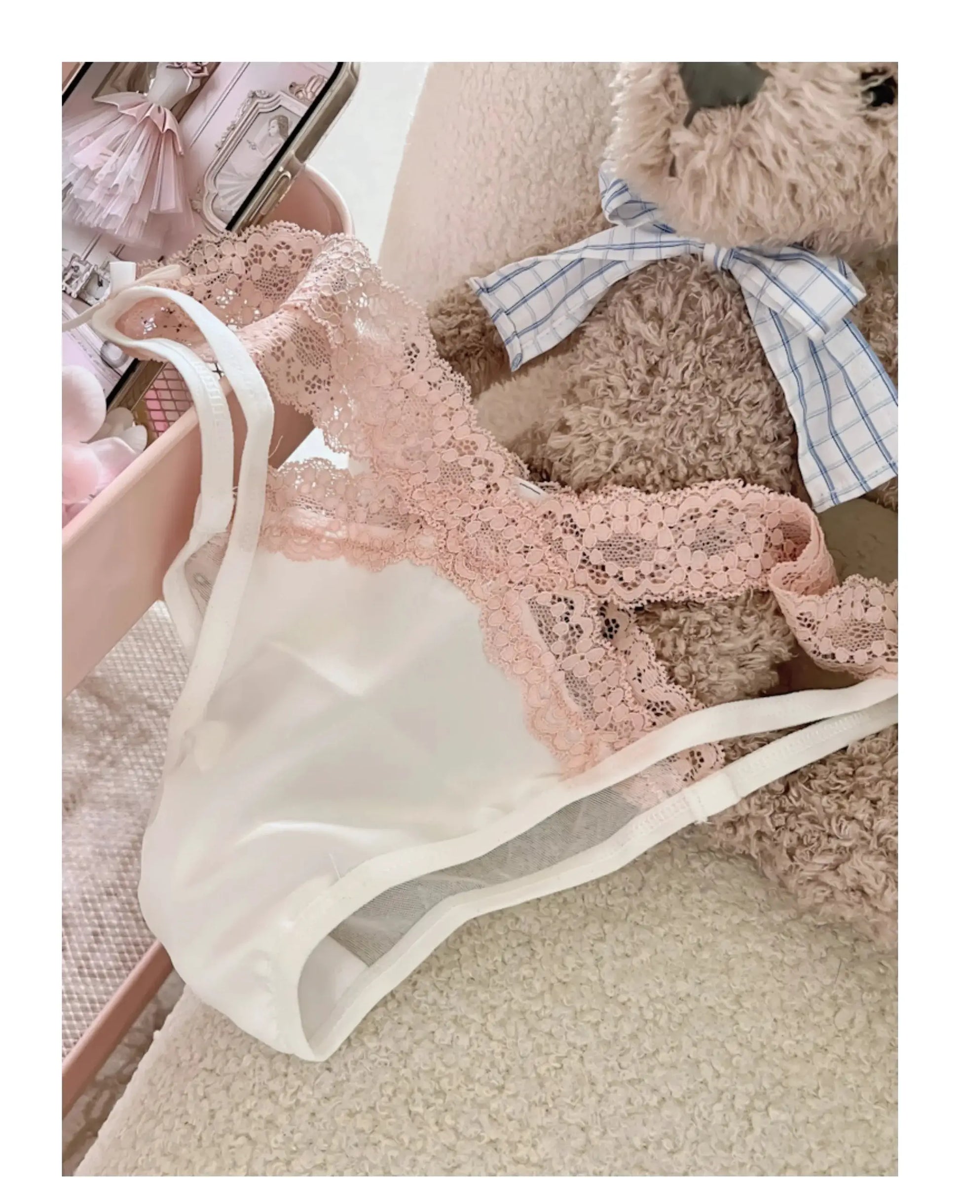 Pink lace cross-belt panties with bow, low-waist mesh underwear, displayed beside a plush teddy bear.