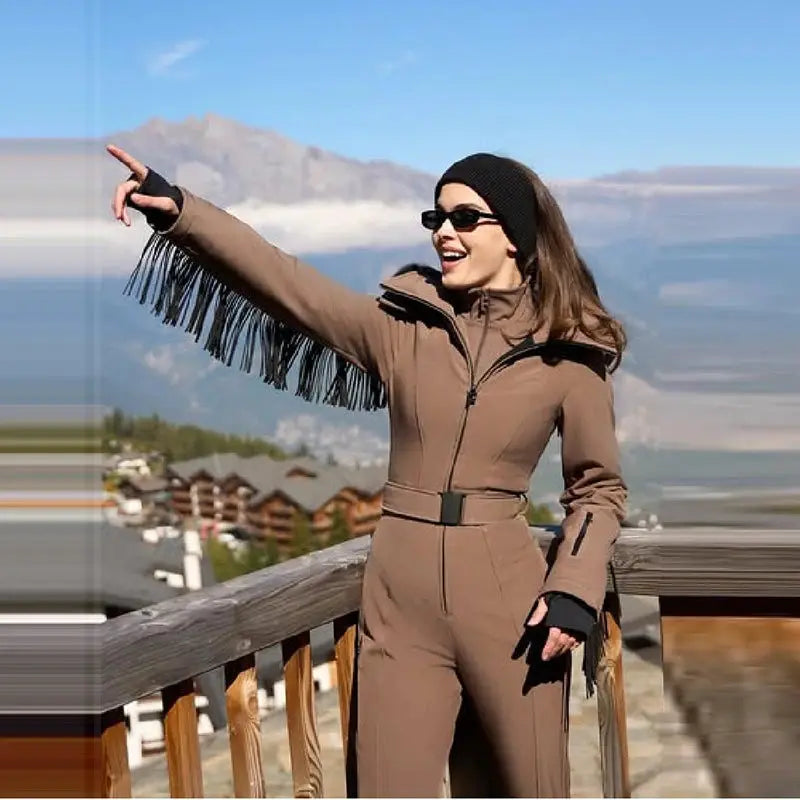 Women's tan ski jumpsuit with belt and faux fur hood tassel fringe for windproof winter wear