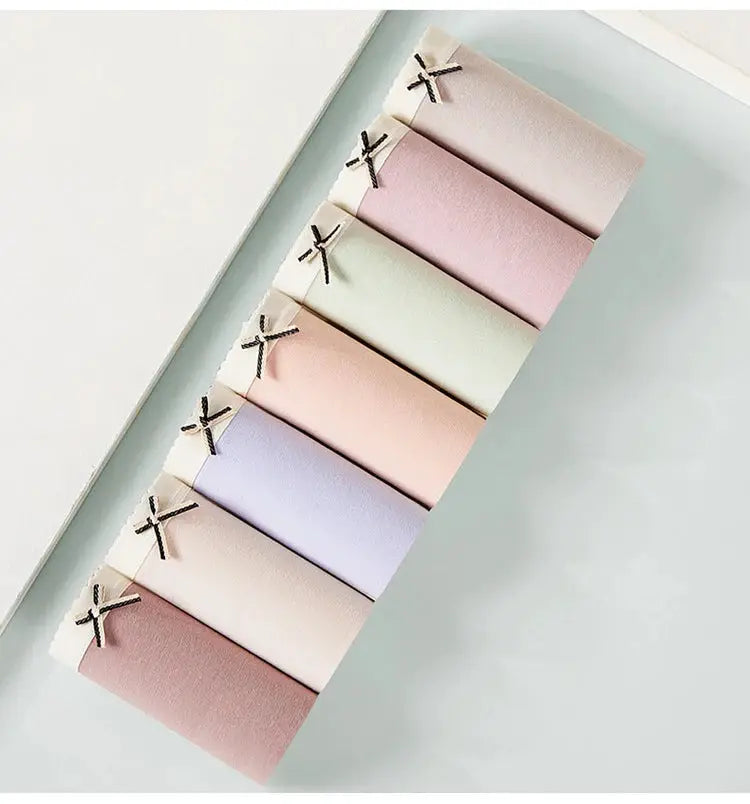 Panties 7-pack cotton women's underwear in pastel solid colors with bow accents.