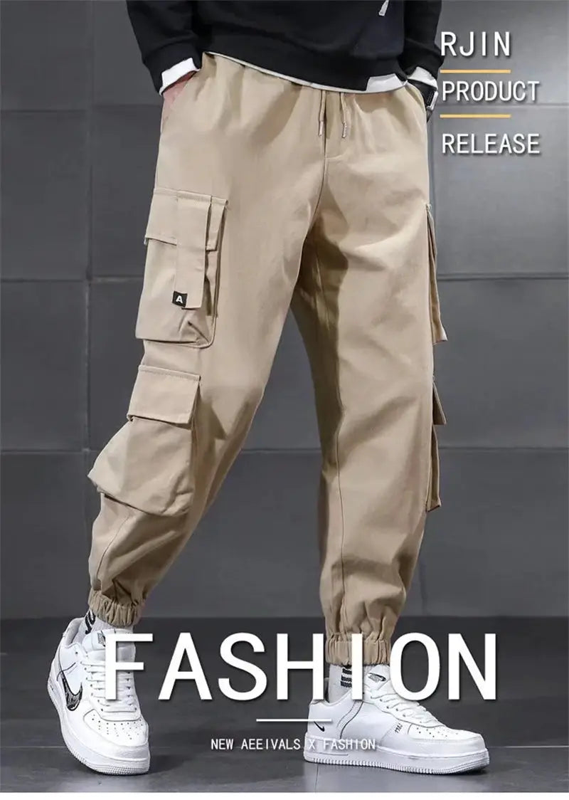 Men's beige cargo pants with multiple pockets, drawstring waist, and elastic cuffs