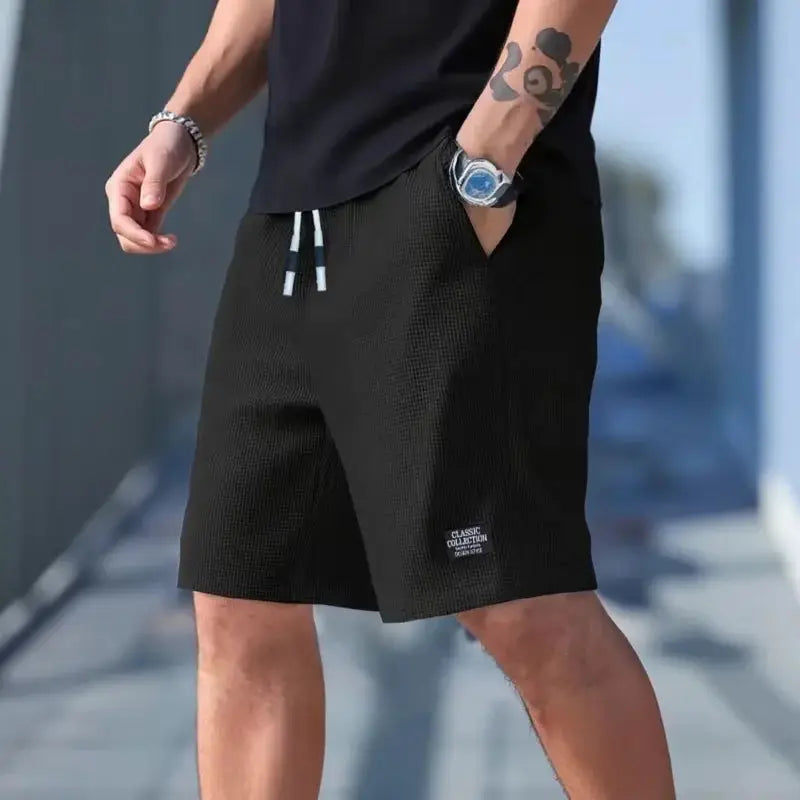 Men's black textured shorts with drawstring waist and breathable fabric for casual athletic wear.