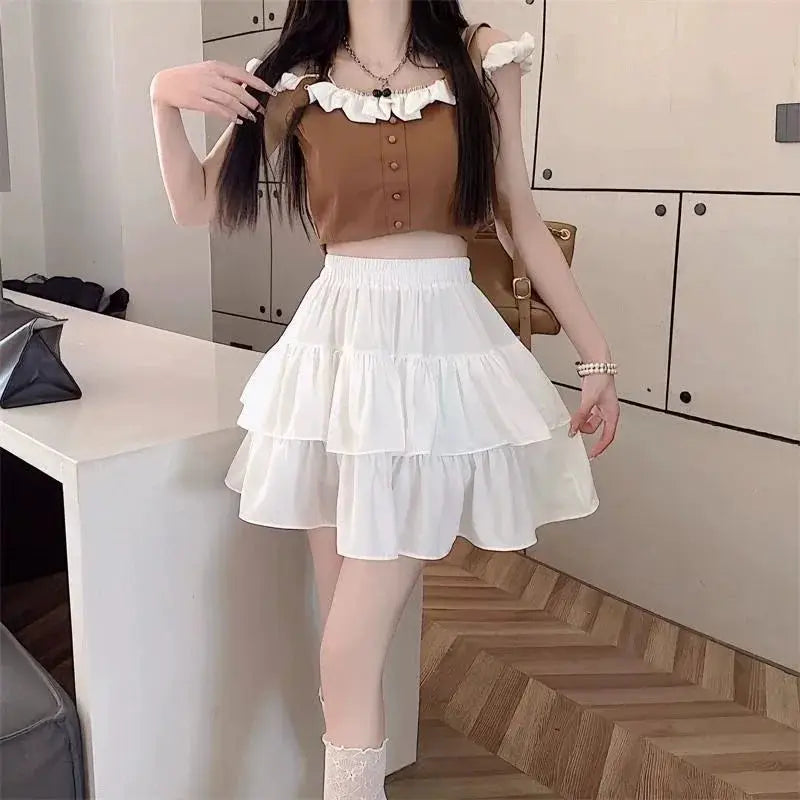 Mini white tiered A-line skirt with layered ruffles and high-waist fit, styled with a brown crop top