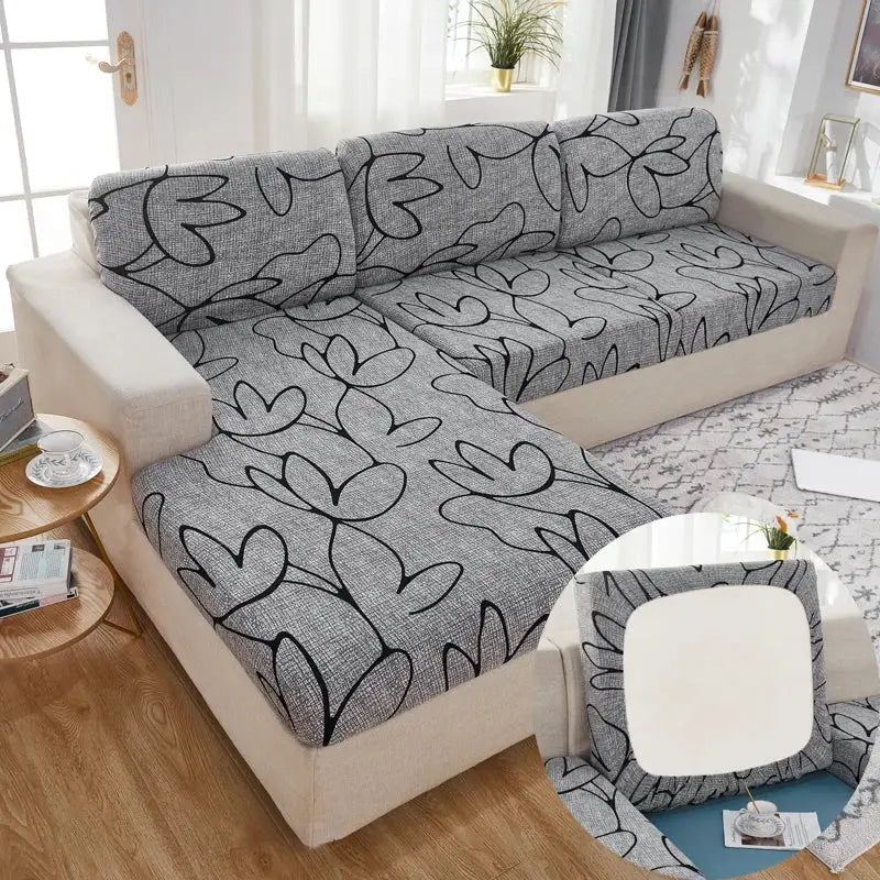 Sofa slipcovers by Simples Market; gray floral stretch fabric with black leaf pattern for L-shaped couch.