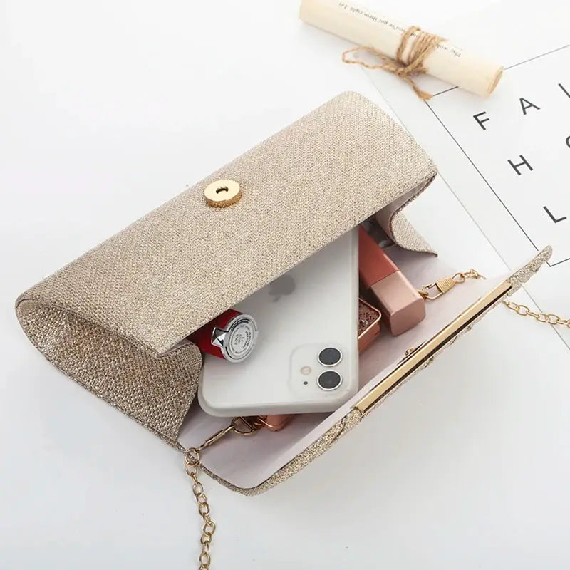 Sequined evening clutch with chain strap in champagne gold by Simples Market