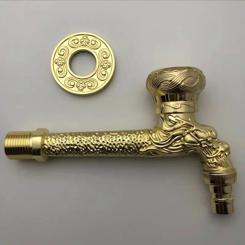 Outdoor faucet with antique brass finish, wall-mounted ornate carving and round escutcheon plate.