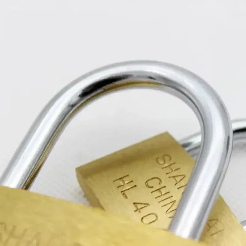 Copper padlock with silver shackle; brass body close-up
