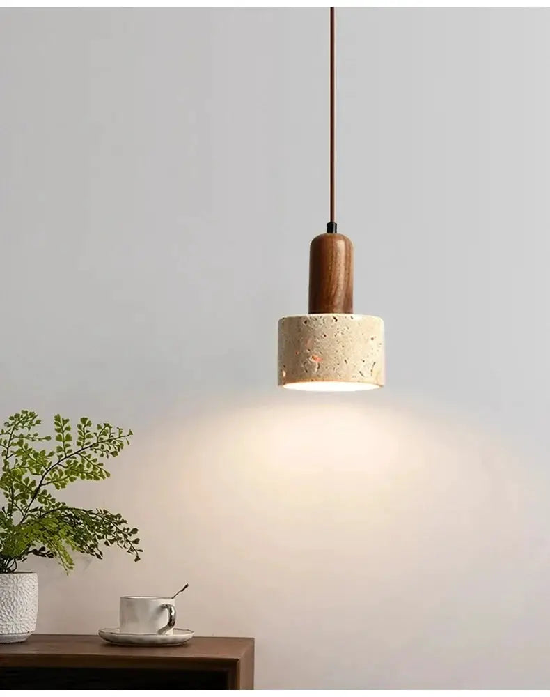 Wabi Sabi travertine pendant light with wooden cap and brown cord, warm dining glow