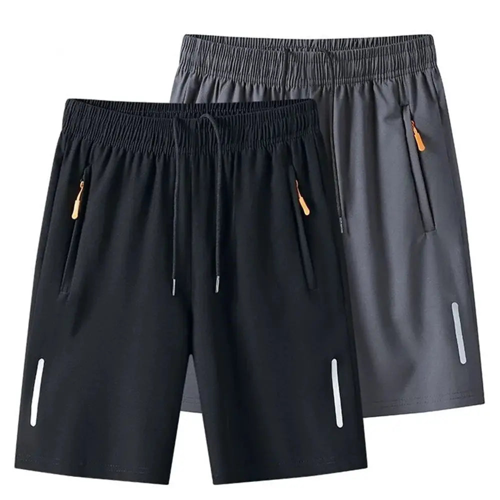 Two pairs of men's quick-dry athletic shorts, black and gray, with drawstrings, zip pockets, and reflective side stripes