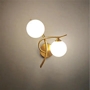 Nordic modern iron wall lamp with two glass globe bulbs in brass finish by Simples Market