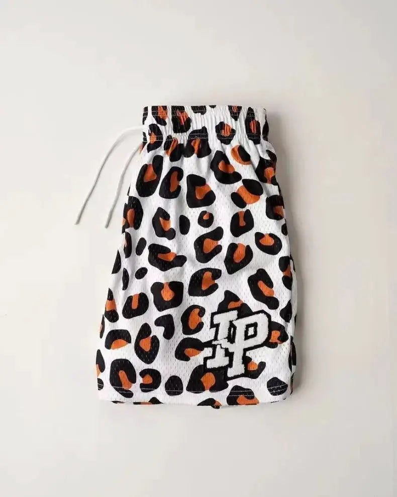 Men's leopard-print mesh shorts with drawstring waist, white with black and orange spots