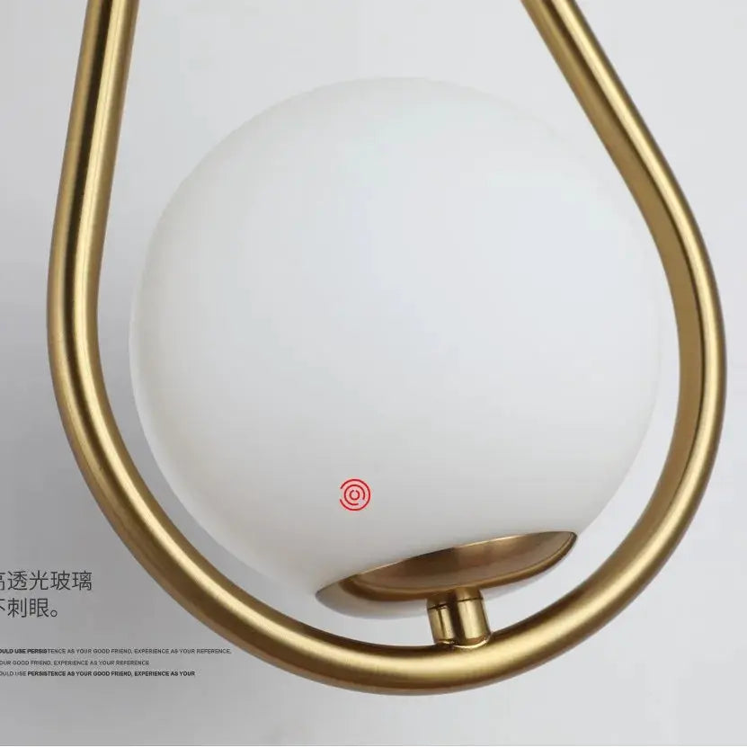 Glass ball LED wall lamp with gold metal frame and red touch sensor for modern minimalist living room lighting