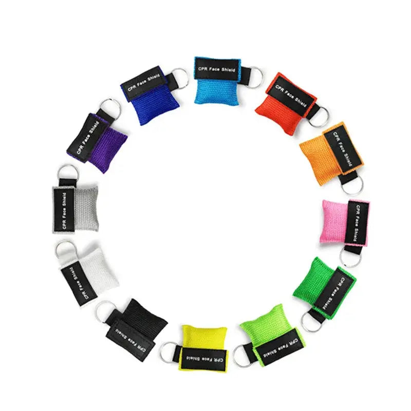 Keychain CPR face shield masks in multiple colors arranged in a circle