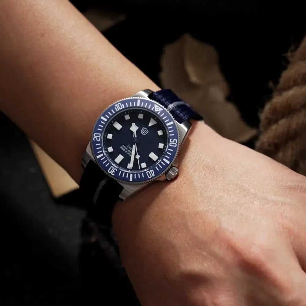Watchdives EXD 40mm titanium dive watch on wrist with blue bezel, blue dial, and navy fabric strap