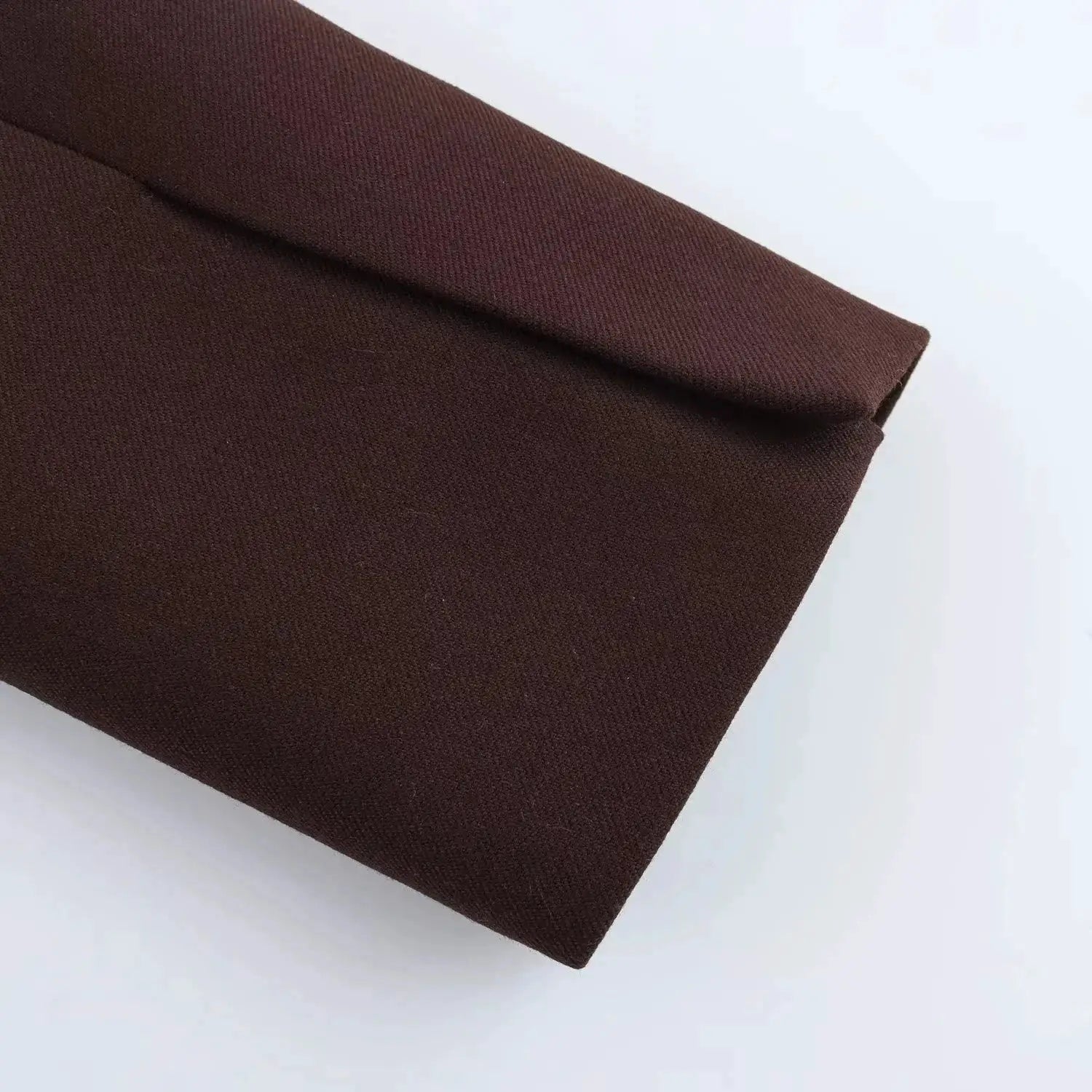 KONDALA brown blazer sleeve close-up on solid fabric