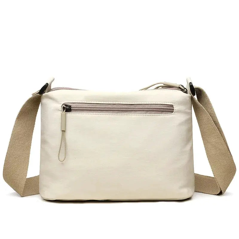 3 Main Pockets High Capacity Shoulder Crossbody Bag beige canvas with tan adjustable strap and front zip pocket