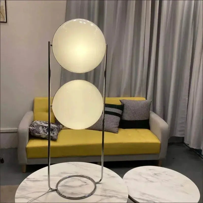 Modern white acrylic circular LED floor lamp with twin globe shades by Simples Market