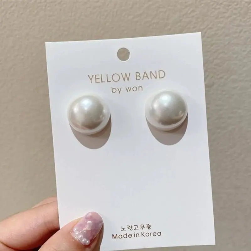 Imitation pearl round stud earrings, 2 cm, white pair on display card labeled Yellow Band by won