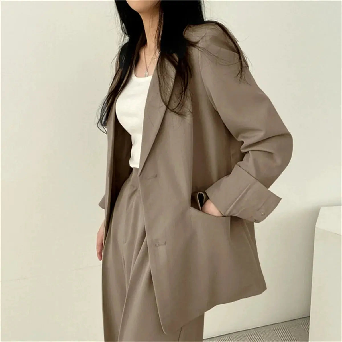Taupe women's blazer and wide-leg pants suit set for office wear by Simples Market.