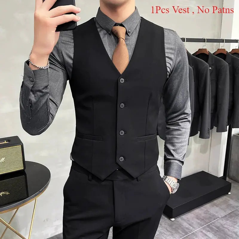 Men's black waistcoat over gray dress shirt with brown tie; formal suit vest