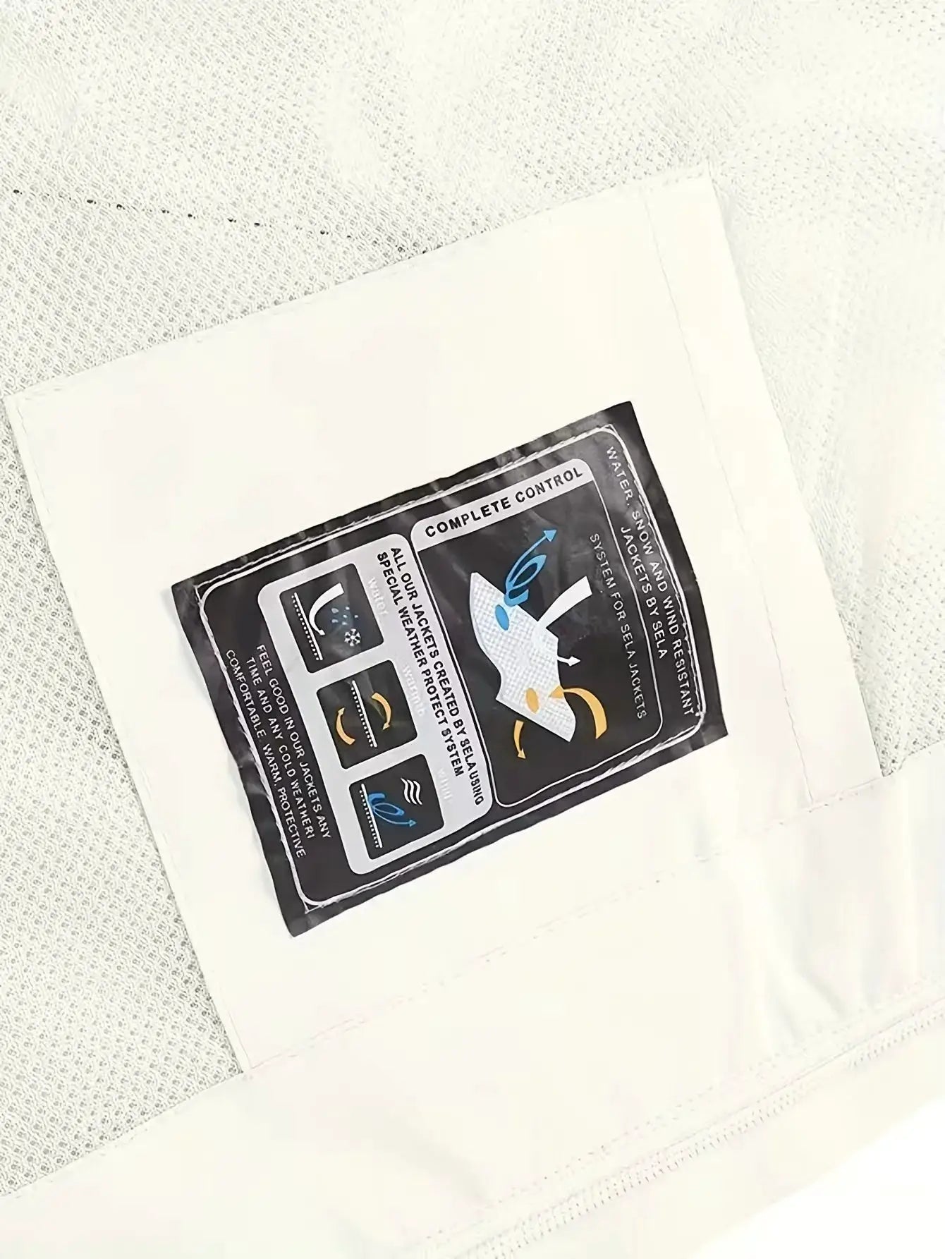 Men's waterproof rain jacket packaging on white mailer; black instruction label with feature diagrams.