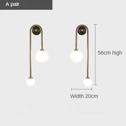 Modern wall lamp pair by Simples Market with glass ball shades in a gold finish, 56 cm high and 20 cm wide.