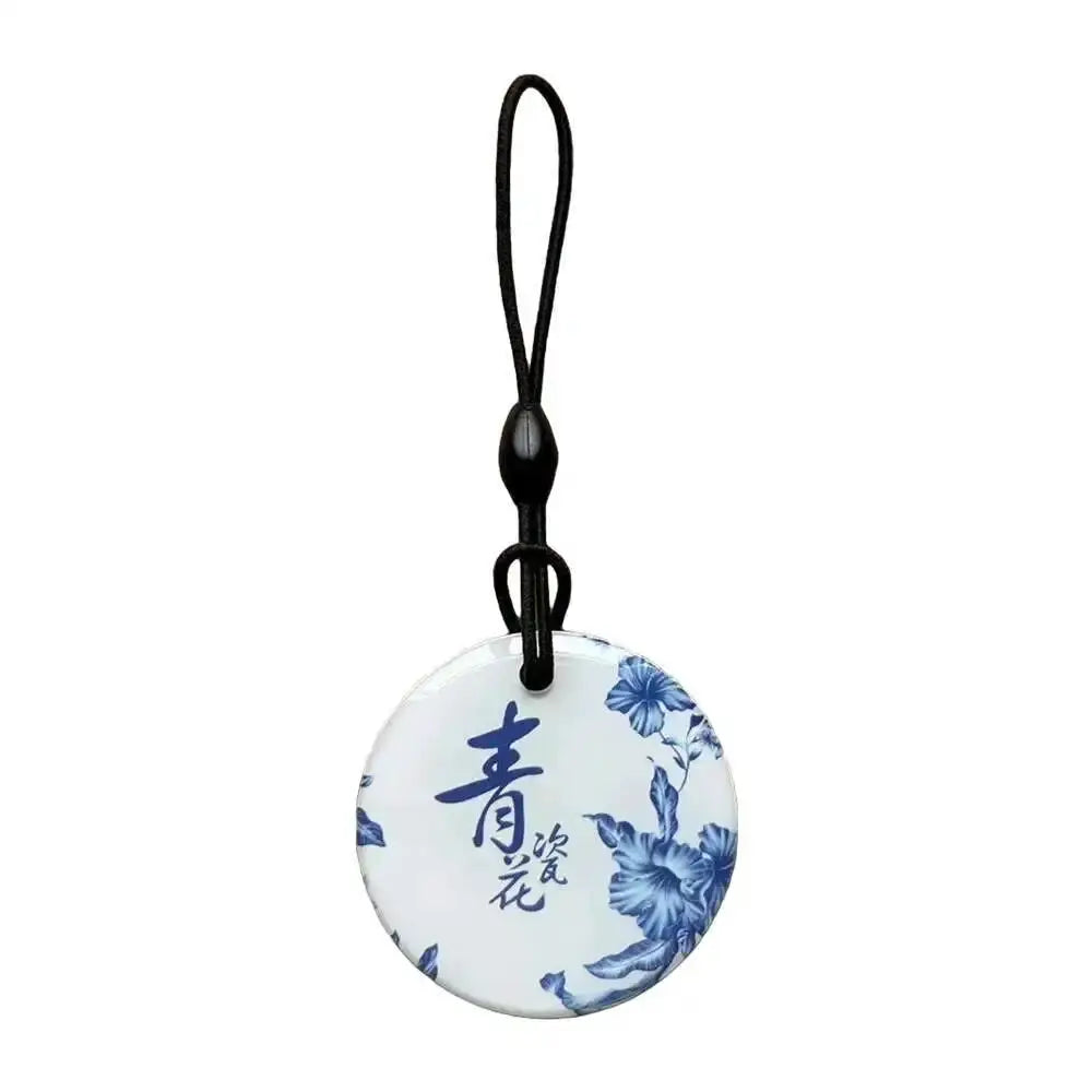 Simples Market round RFID key tag with blue floral pattern, waterproof, attached black lanyard