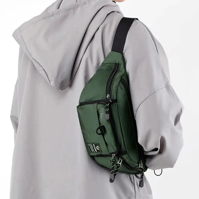 Simples Market men's green nylon waist bag with multiple pockets worn as a sling on the back