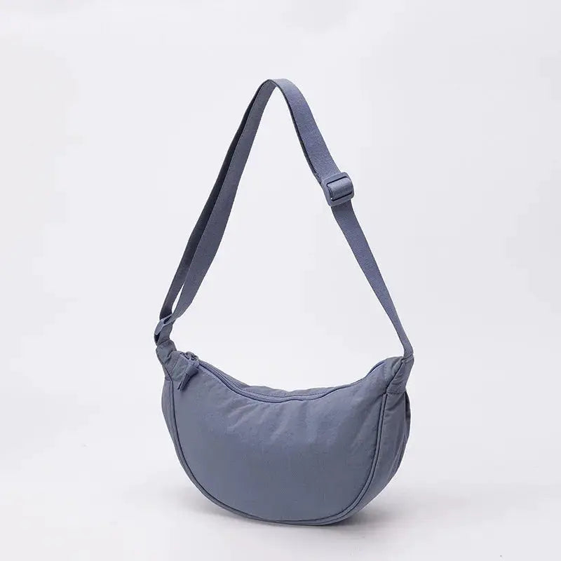 Nylon crossbody bag by Simples Market, crescent-shaped dumpling design in blue-gray with zipper closure