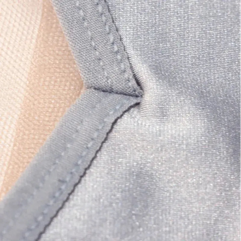 Low-waist light-blue briefs fabric close-up showing neat stitching and smooth texture