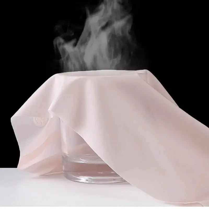Panties pink ice-silk ultra-thin fabric draped over glass with steam