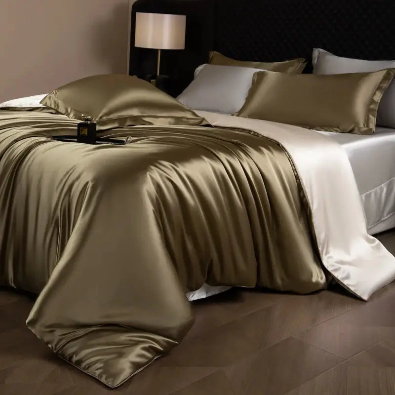 Silk bed sheets set by Simples Market with duvet cover, fitted and flat sheets, and pillowcases in champagne gold satin.