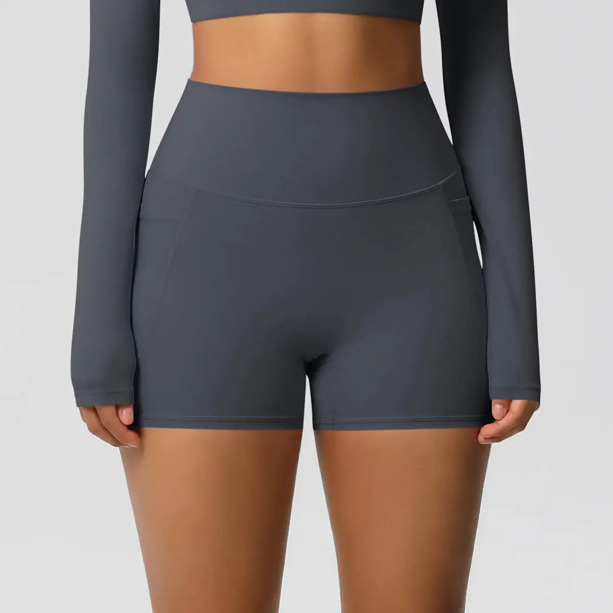 Women’s dark gray high-waisted pocketed athletic shorts for yoga and workouts