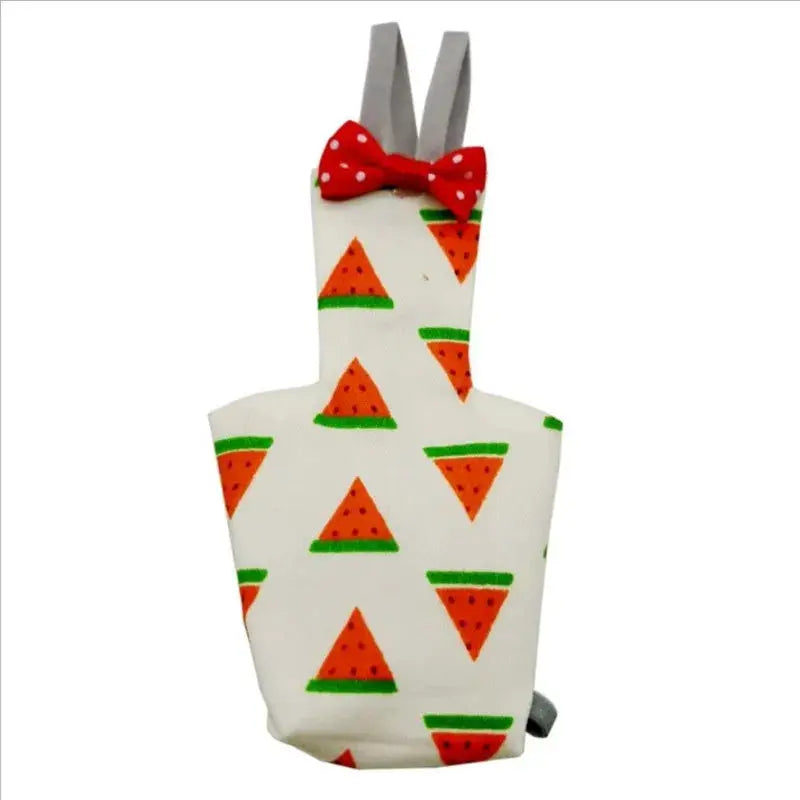 Parrot diaper with bowtie; white fabric covered in orange watermelon slices, red polka-dot bow, grey suspenders