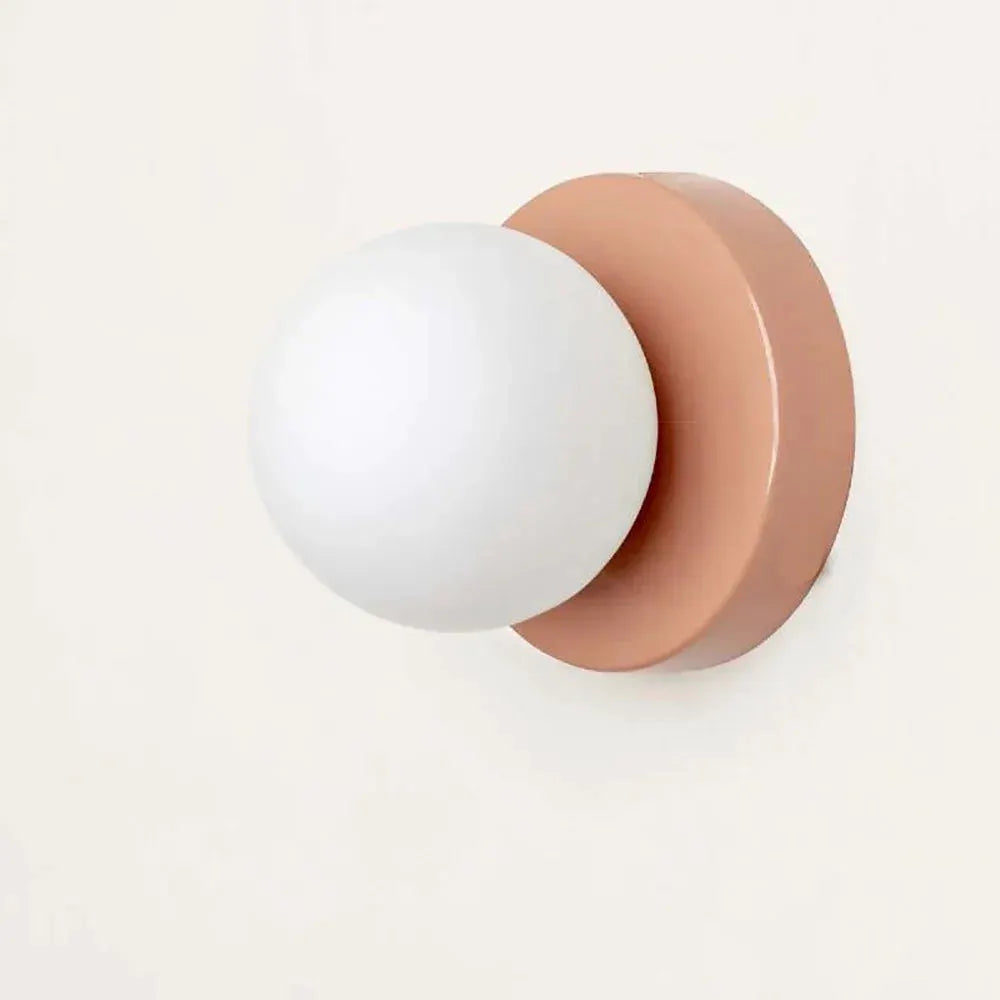 Nordic Macaron LED wall lamp; pink round mount with white glass globe.