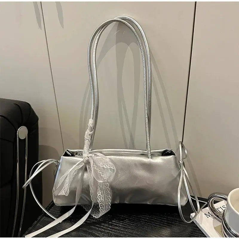 Silver metallic square shoulder bag by Simples Market with a lace bow decoration