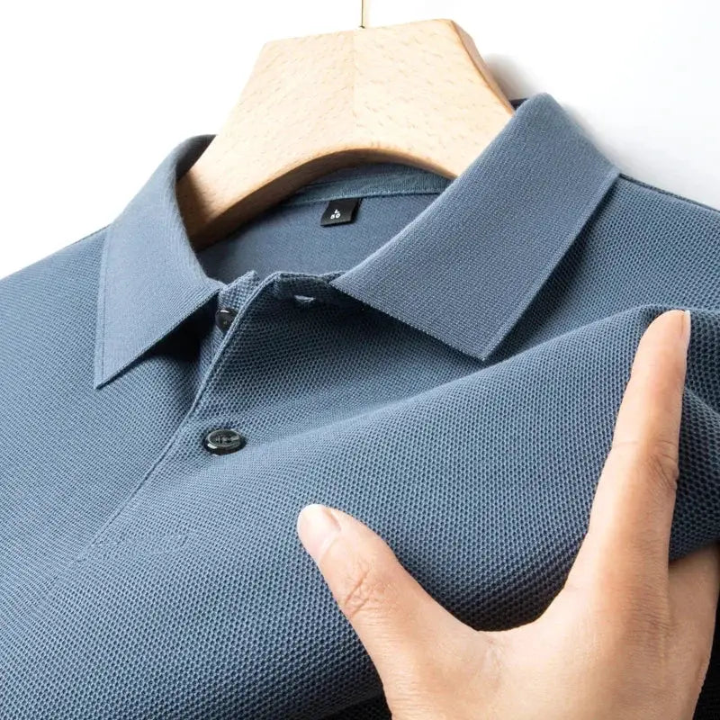 Men's blue polo shirt, 100% cotton with a textured knit and classic collar.