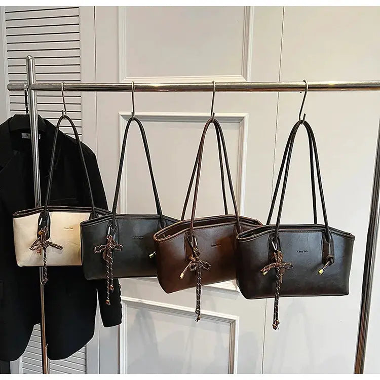 Simples Market PU leather shoulder bags for women; four colors (cream, gray, brown, black) with tassel charms.