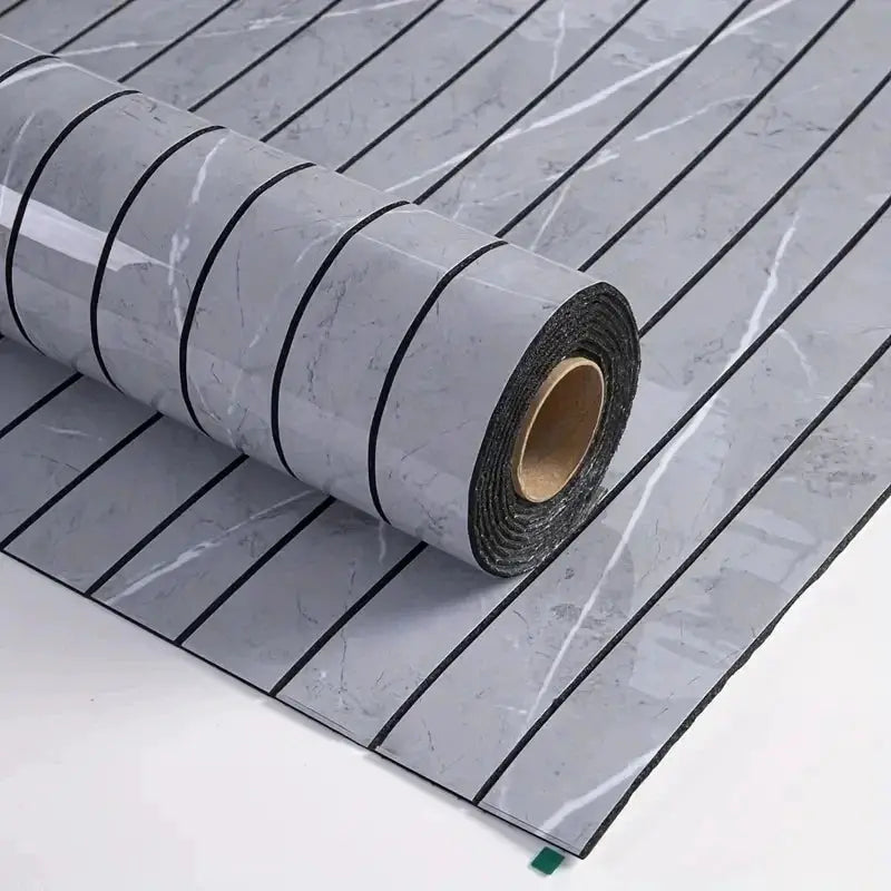 Self-adhesive wallpaper roll in gray marble-style pattern with black vertical stripes, rolled on a cardboard core
