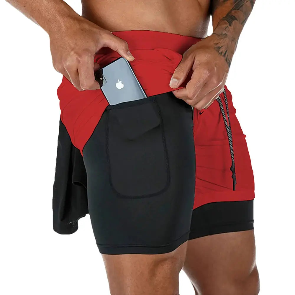 Men's 2-in-1 quick-dry fitness shorts in red outer layer with black inner liner and phone pocket.