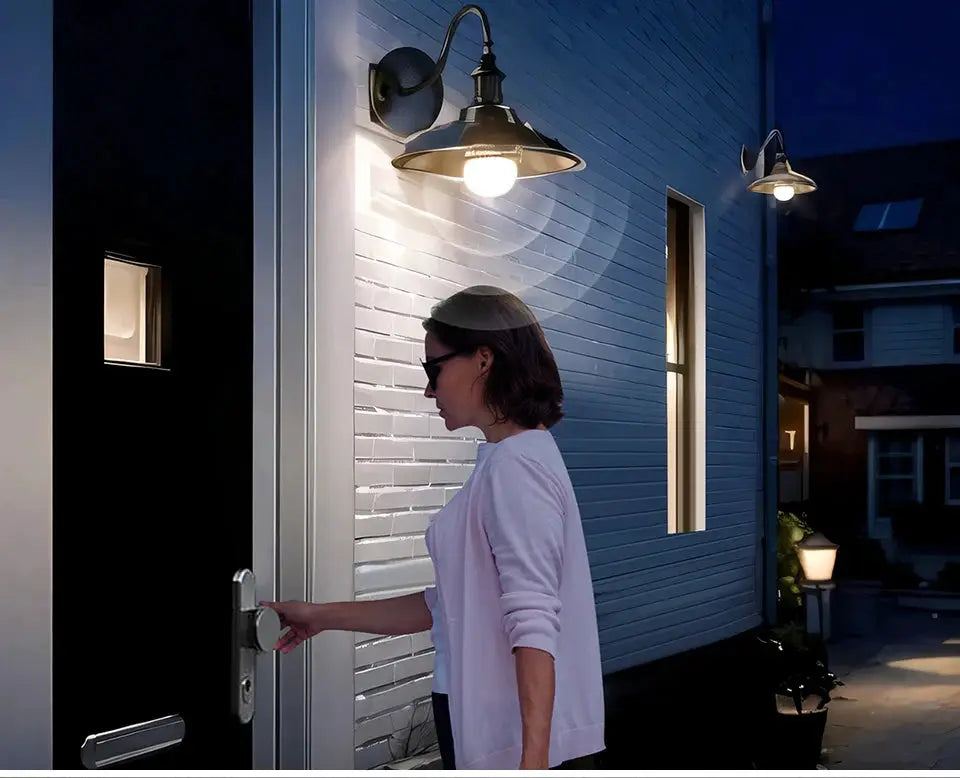2-pack white LED night lights with motion sensor mounted on exterior wall near a door