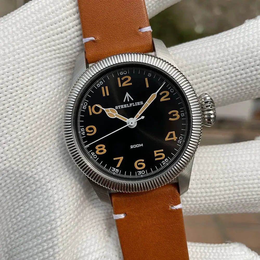 STEELFLIER SF741 wristwatch with black dial, gold numerals, tan leather strap, stainless steel case