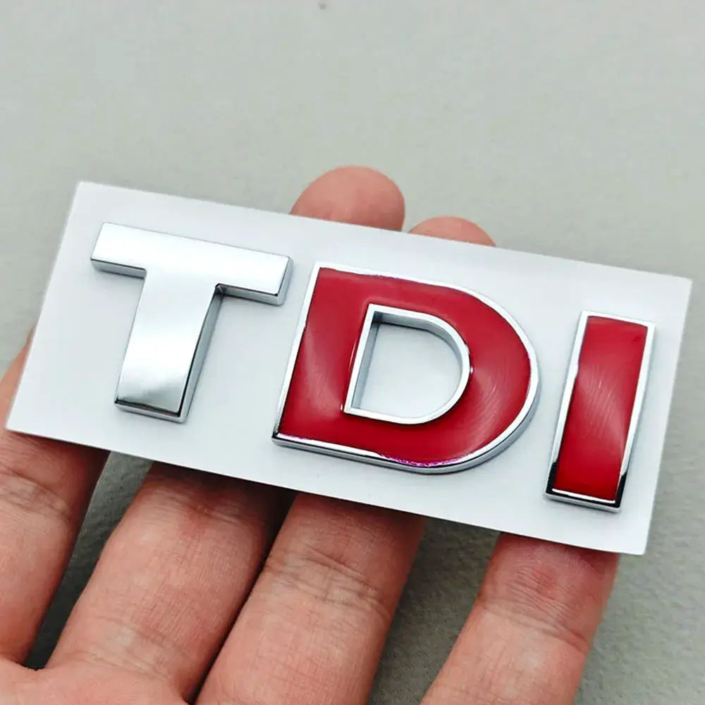 3D TDI car trunk badge with chrome T and I and red enamel D on white backing plate