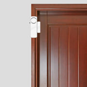 Wireless door/window magnetic sensor alarm detectors (2-pack) by Simples Market mounted on a wooden door frame